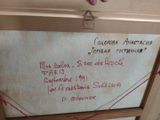 a white board with writing on it hanging on a wall
