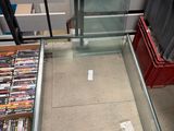 a glass table with a lot of dvd ' s on it