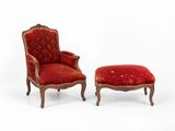 pair of red upholstered chairs and a foot stool