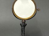 an antique brass plate with a mirror on top of it