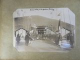 an old photo of a group of people walking down a street