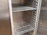 an open refrigerator with a lot of shelves inside of it