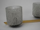 pair of glass votives on a wooden stand on a white surface