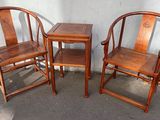 three wooden chairs and a table in front of a white wall
