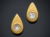 a pair of gold and diamond earrings