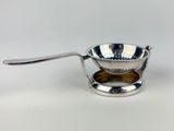 a metal strainer with a spoon in it