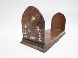 a small wooden bookend with a bird design on it