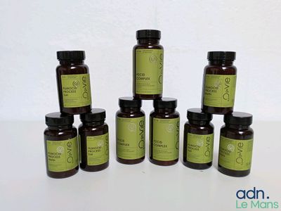 a group of bottles of olive oil sitting on top of a table