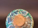 a close up of a bowl on a black surface