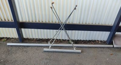 a pair of ski poles leaning up against a wall
