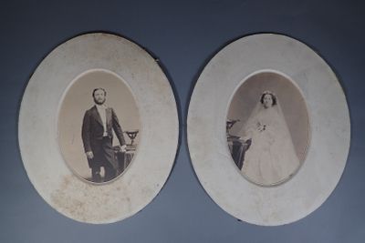 two old photos of a man and a woman on the wall