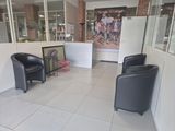two black chairs in a room with a picture on the wall