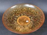 a glass bowl with a design on it on a table