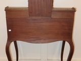 a small wooden table with a mirror on top of it