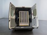 a white van with its doors open in a room