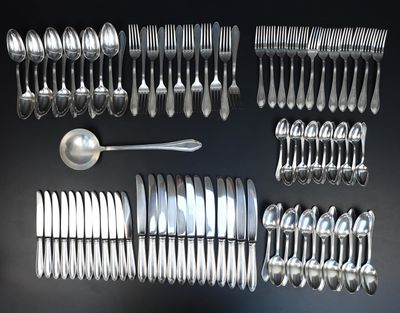 a lot of silver spoons and silverware on a table