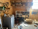 an image of a room with a refrigerator and shelves