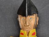 a close up of a toy soldier on a black background