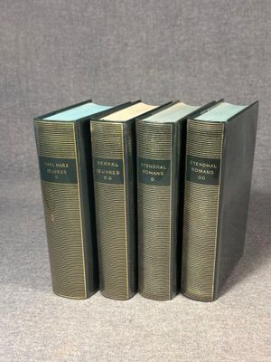 three books sitting on top of each other on a table