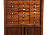 an old wooden cabinet with many drawers and brass pulls