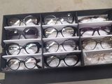 many pairs of glasses in a display case