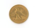a gold coin with a bird on it on a white surface