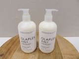 two bottles of olaplex hand lotion on a wooden tray