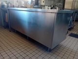 a stainless steel counter in a kitchen with a tile floor