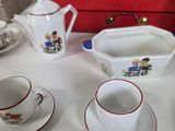 several cups and saucers are sitting on a table with a red box in the background