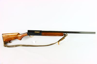 the rifle is laying on a white surface and ready to be used