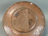 a brown plate with a picture of a woman on it