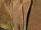 a close up of a military jacket with buttons on it
