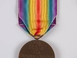 a medal with a ribbon around it on a white surface