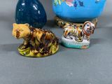 three small figurines of animals sitting next to each other