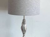 a lamp that is sitting on a table next to a wall