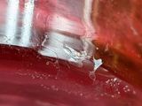 a close up view of a glass of red liquid