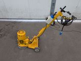 a yellow machine that is sitting on the ground