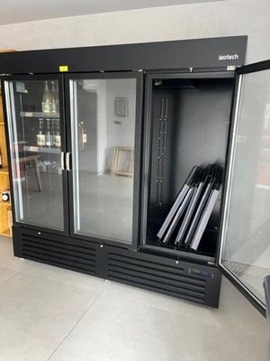 an image of a glass doored refrigerator in a room