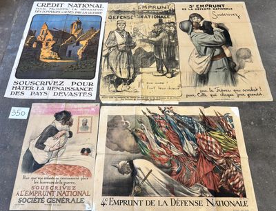 several old french posters are on display on a table
