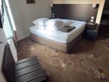 a picture of a hotel room with a bed and a chair