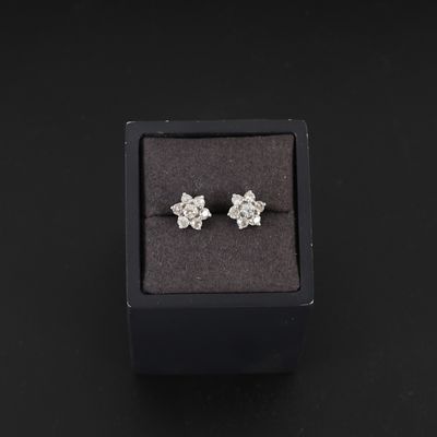 an image of a pair of diamond stud earrings in a black box