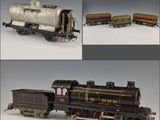 three different views of a model train engine with a tank on the front