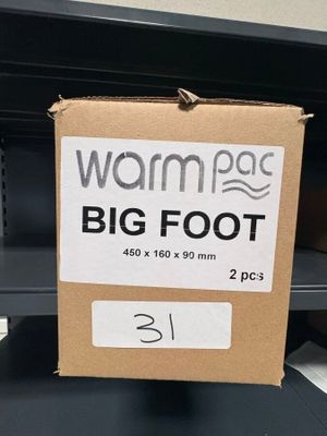 une boîte en carton sur laquelle est accrochée une pancarte indiquant « warmage big foot »