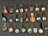 many different types of badges on a black surface