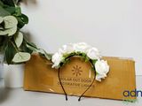 a white flower headband with white roses on it