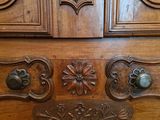 a large wooden cabinet with a drawer on top of it