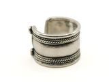 gros plan d'une bague en argent sur une surface blanche
