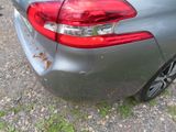 a close up of a car ' s tail light on a gravel road