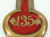 a red and gold plaque with the number thirteen on it