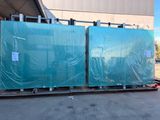 two large blue plastic panels on a pallet in front of a building